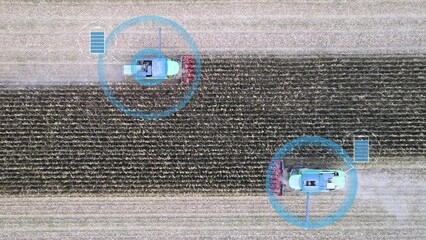 Automated electric combine harvesters, cutting crops in farms. Graphics showing battery levels and navigating through AI. Aerial