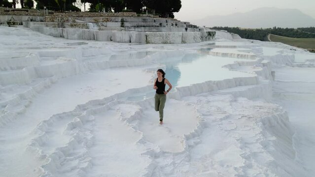 tourist on Natural travertine pools and terraces in Pamukkale. Turkey