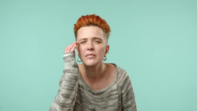 A Focused Lesbian Woman With Fiery Red Hair Squints, Trying To See Something In The Distance, Her Piercing Gaze Concentrated, Against A Soft Teal Backdrop. Camera 8K RAW. 