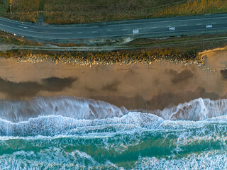 Aerial: Country road and ocean. Oamaru, Otago, New Zealand.