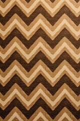 Tan zig-zag wave pattern carpet texture background 