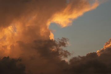 Orange Sunset background with different textures and colors in the clouds.