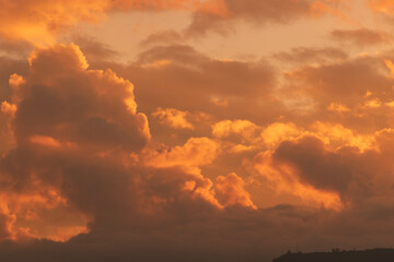 Orange Sunset background with different textures and colors in the clouds.