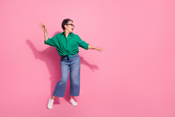 Full size photo of pretty retired female cool dancing celebration wear trendy green outfit isolated on pink color background