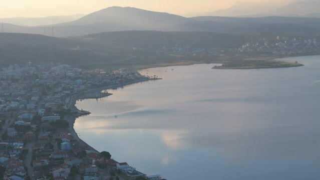 seaside town on a gulf at sunrise time and colors aerial photos clouds at sky and houses of village