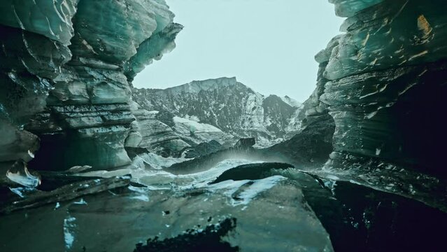 Cinematic shot inside the Katla ice caves, near Vik, southern Iceland.
View of the frozen subglacial landscape. Water falling down the caves walls.