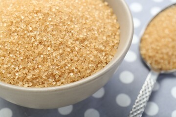 Brown sugar in bowl on table, closeup