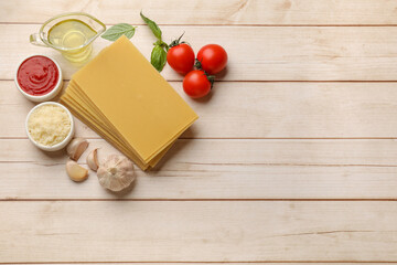 Ingredients for lasagna on white wooden table, flat lay. Space for text