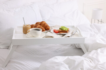 Fototapeta na wymiar Good morning. Tray with tasty breakfast on bed