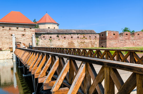 Moated citadel defending walls with a wooden bridge