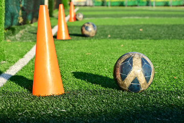 artificial green grass soccer field with training cone and ball