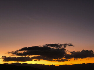Purple sunset with orange and big clouds. Medellin, Antioquia, Colombia.