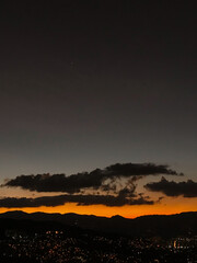 Purple sunset with orange and big clouds. Medellin, Antioquia, Colombia.