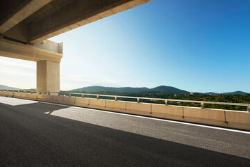 Modern highway road under the overpass with blue sky.