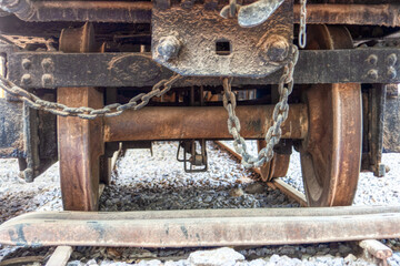 under the wheels of a rusty vintage railway cart from the Rhodesian era