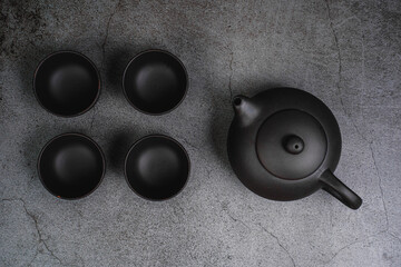 The concept of Asian tea, on a dark background.  Chinese  Tea ceremony.  Japanese Tea set, cups and...