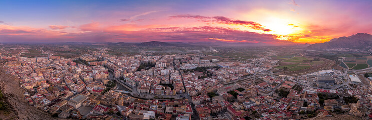 Obraz premium Aerial view of Orihuela in Murcia province Spain medieval town with castle and Gotchic and Baroque churches near the Segura river with dramatic colorful sunset sky