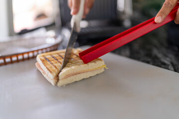 Cook cutting a sandwich in the counter of food truck