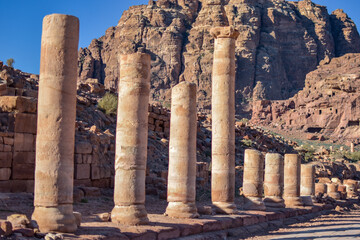 Ancient stone columns on the side of a road in Petra, Wadi Musa, Jordan.