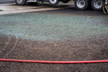 Professional applied hydroseeding, mix of grass seed and wood pulp freshly applied to dirt in a new...