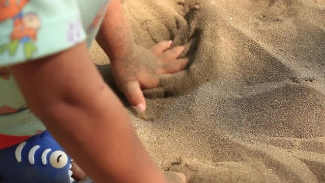 Child playing sand at the beach