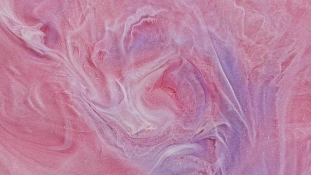 A smooth video sequence featuring mesmerizing patterns resembling a pink floral explosion, providing a serene backdrop. The abstract texture includes shimmering sparkles.