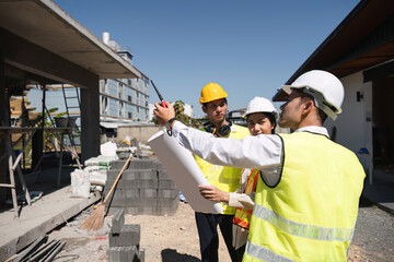 Team of professional civil engineers and architects holding project plan paper, supervising and controlling construction project work at construction site. - obrazy, fototapety, plakaty