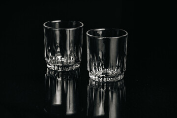Black and white isolated empty Whiskey drinking crystal clear glasses with reflections