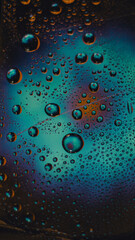 Abstract blue textured background, drops of azul water on tape with reflection of a flower in drops.