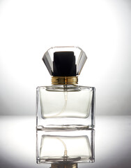 Realistic glass perfume bottle on abstract background. Empty perfume bottle.