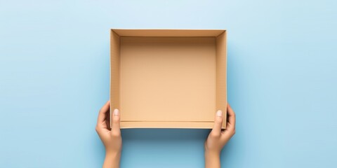 One empty open brown cardboard box on blue background. Top view - obrazy, fototapety, plakaty
