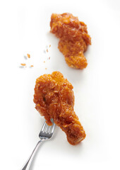 Delicious hot crispy fried chicken on a fork isolated on white background. Korean fried chicken