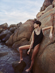 Stunning Summer Siren: A Beautiful, Happy Woman in Sexy Swimwear Poses on the Beach, her Slim Body...