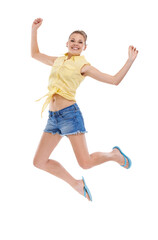 Fototapeta na wymiar Excited, jump or portrait of girl teenager in studio for news, announcement or bonus prize. Energy, smile or happy model winner in celebration of fashion discount, success or sale on white background