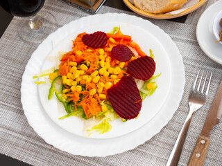 Fresh vegetable salad with corn, carrots and beets