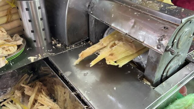 Preparation of cane drink Vendor is extracting the fresh juice from raw sugarcane using sugarcane juice machine.It is established for muslim to break fast during the holy month of Ramadan