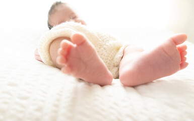 Newborn baby feet photographed on white background. Tiny baby feet closeup