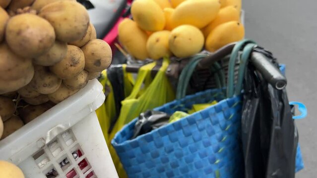 Mangoes Tropical Fruits Displayed Asian Southeast Market Store Dolly shot closeup to Lansium domesticum Longkong, Duku