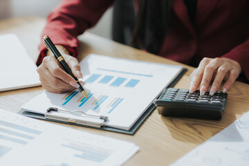 Close-up view of business woman working and analyzing laptop with statistics of financial data graphs for new project of business strategy and market growth at work