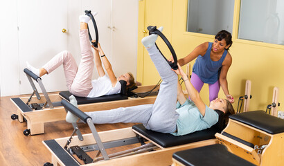 Teens training in pilates lessons led by a female trainer