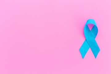 Blue ribbon symbol of prostate or colon cancer awareness concept