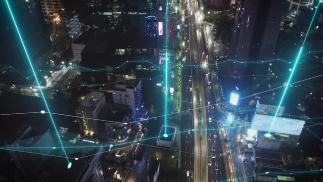 High angle view of busy multilane thoroughfare in modern metropolis. Aerial evening shot of traffic in streets of city. Jakarta, Indonesia. Added augmented reality visual effects