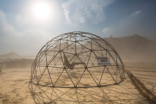 Dome structure in a dusty sand storm with information sign