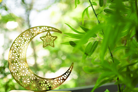 crescent moon on the natural green background, Eid Mubarak and Ramadan Kareem background, Half moon isolated on green bokeh background, 2025 Ramadan concept poster image with copy space for text - Powered by Adobe