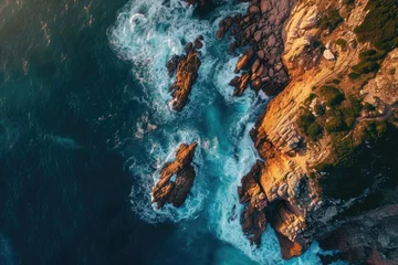 Fotobehang This aerial photo captures the expansive view of the ocean and the rugged rocks along the coastline, Aerial perspective of the sea kissing rocky shores at dawn, AI Generated © Iftikhar alam