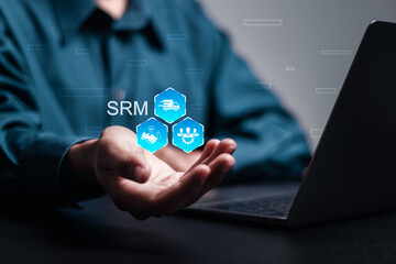 SRM, Supplier Relationship Management concept. Businessman hold virtual screen of SRM icon for cooperation business, supplier, risk management, strategy, contract and optimization.
