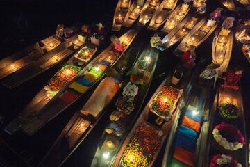 Damnoen Saduak Floating Market or Amphawa. Local people sell fruits, traditional food on boats in canal, Ratchaburi District, Thailand. Famous Asian tourist attraction destination. Festival in Asia.
