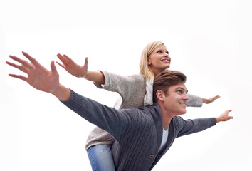 Couple, piggy back and airplane with arms, smile and funny game with care for connection with bonding outdoor. Man, woman and playful with plane, wings or flight for freedom on journey for vacation