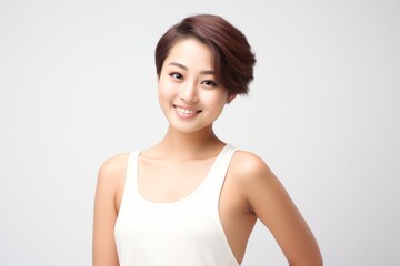 Adorable young girl clad in snug vest undergarments, showcasing her style against a pristine white background. Generative AI.