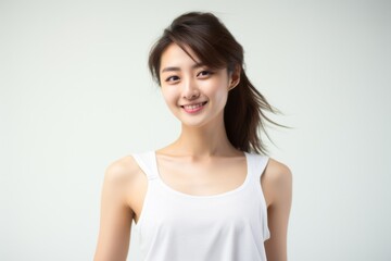 Obraz premium Sweet little girl donning comfy vest lingerie, posing with confidence on a clean white surface. Generative AI.